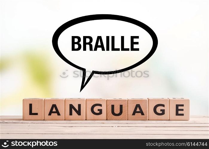 Braille language lesson sign made of cubes on a table