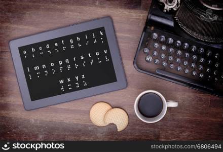 Braille on a tablet, concept of impossibility, vintage look