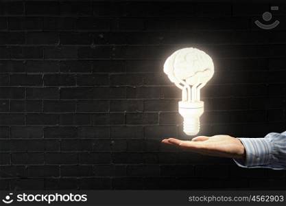 Brain in male hand. Businessman holding image of human brain in palm