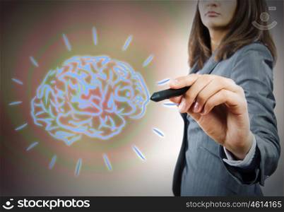 Brainstorming concept. Close up of businesswoman drawing human brain with pen