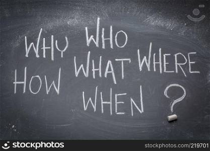 brainstorming questions (what, when, where, why, how, who) - white chalk handwriting on a blackboard