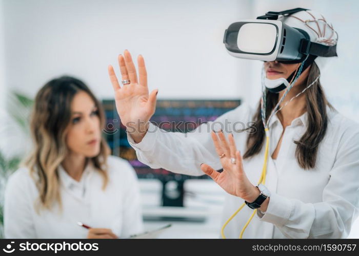 Brainwave EEG Experiment in Neuroscience Research Laboratory. Female Patient Using VR or Virtual Reality Goggles