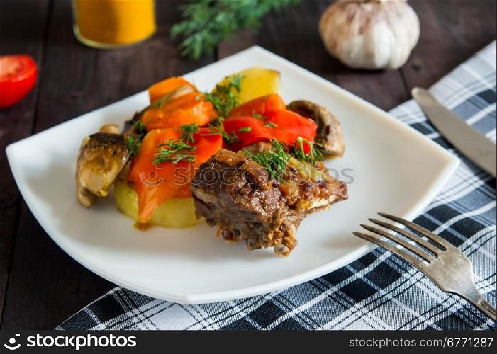 Braised lamb ribs with vegetables on white plate