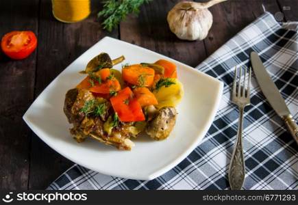 Braised lamb ribs with vegetables on white plate