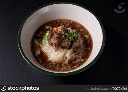 Braised pork noodles Thai street food isolated in black background