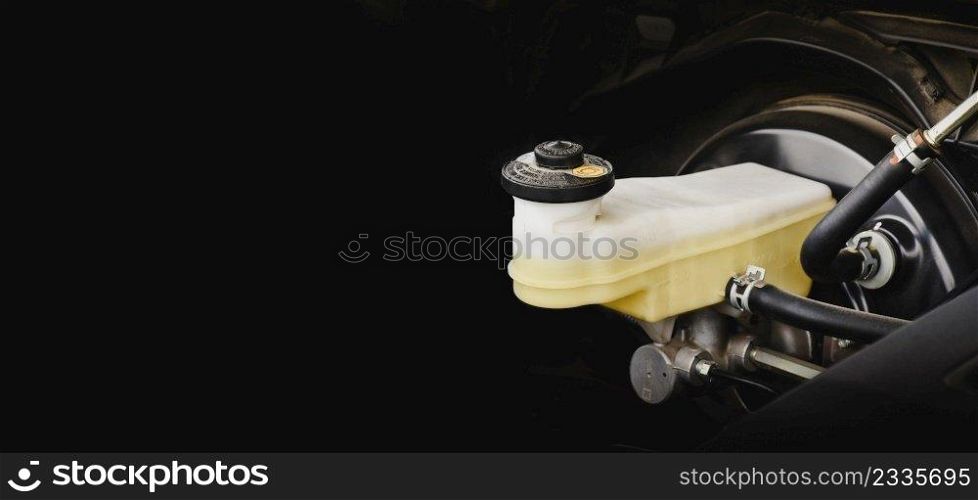 Brake fluid reservoir of car brake system with horizontal copy space on black background