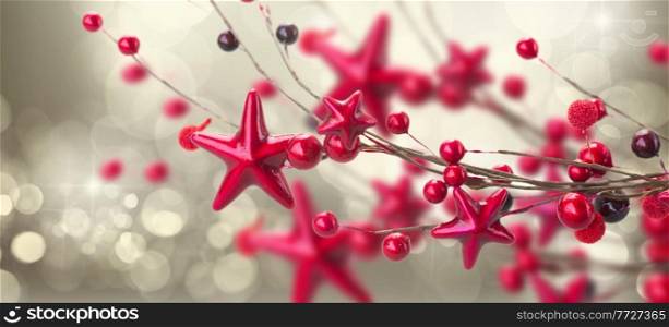 branch of christmas stars and berries on silver bokeh background. branch of christmas stars and berries 