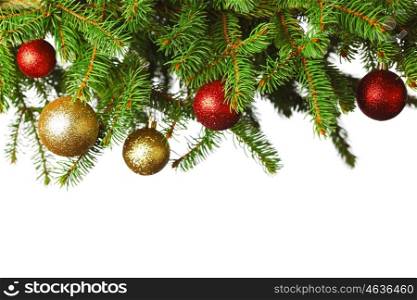 branch of Christmas tree with red and golden glass balls isolated on white background