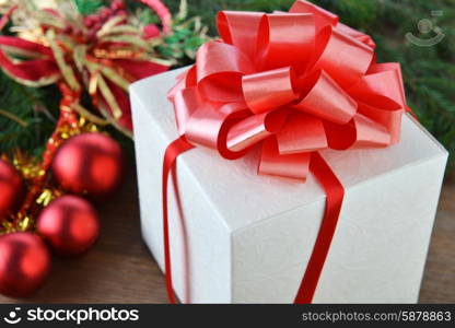 branch of green fir tree with christmas toys on wooden background