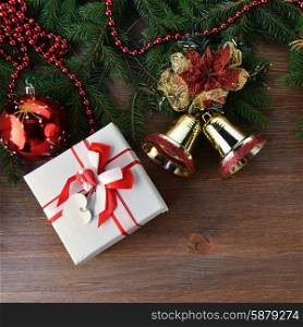 branch of green fir tree with christmas toys on wooden background