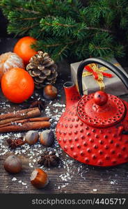 Branch of pine,tangerines,cinnamon on background of Christmas decorations