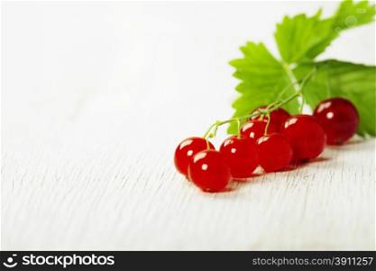 branch of red currants on rustic background
