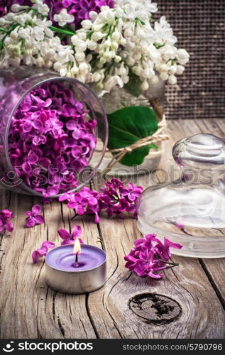 branches of blossoming lilac on wooden background.