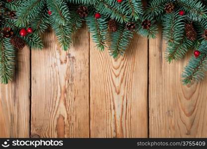 Branches of pine wood with cones and briar on wood background. Copy space