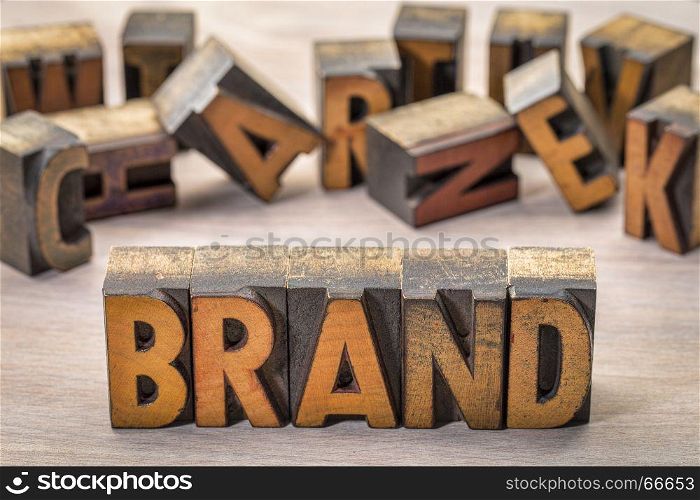 brand word in vintage letterpress wood type blocks against grained wood