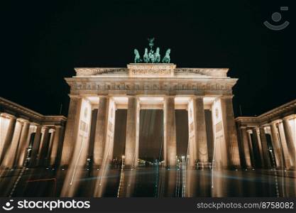Brandenburg Gate stands on Pariser Platz. Construction is illuminated. Night sky background. High quality photo. Brandenburg Gate stands on Pariser Platz. Construction is illuminated. Night sky background.
