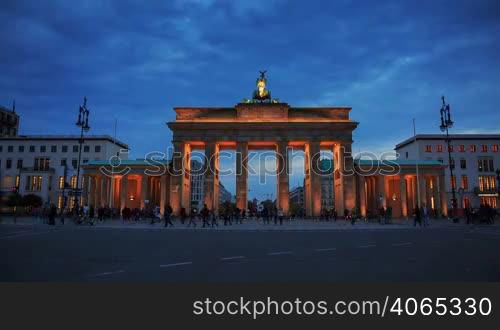 Brandenburg gates in Berlin with crowd and urban transport timelapse