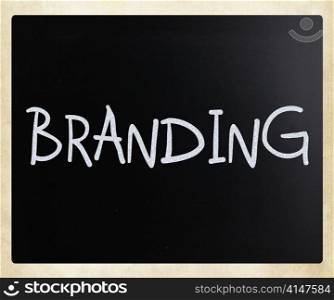 ""Branding" handwritten with white chalk on a blackboard"