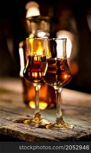 Brandy in a glass on a wooden table