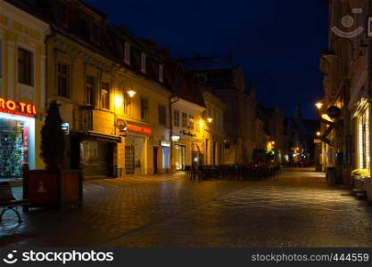 BRASOV, ROMANIA NOVEMBER 1, 2017: view of the street in the historic city center Brasov illuminated by the street lamps. BRASOV, ROMANIA, November 1, 2017