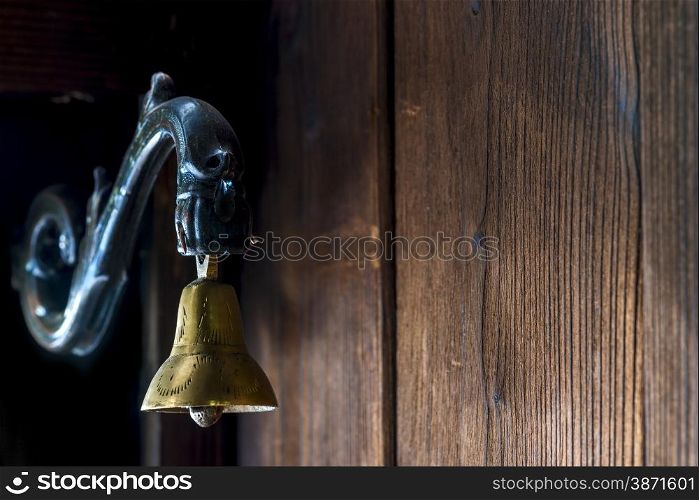 brass bell at the door to the old style