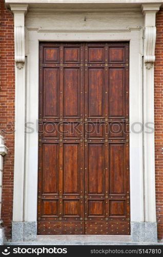 brass brown knocker and wood door in a church crenna gallarate varese italy