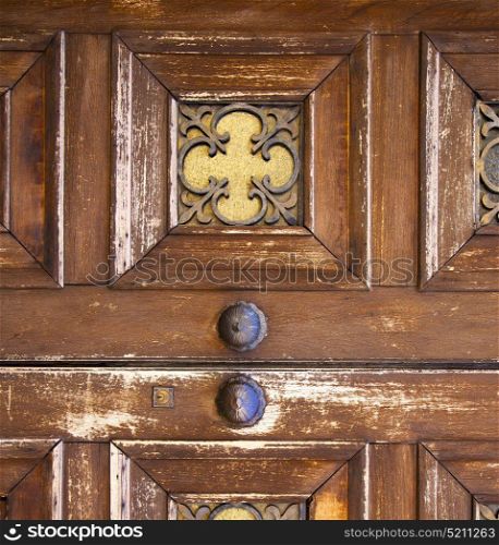 brass brown knocker and wood glass door caronno varesino varese italy