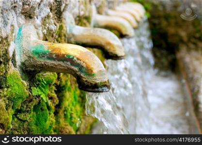 brass fountain water source spring with green moss