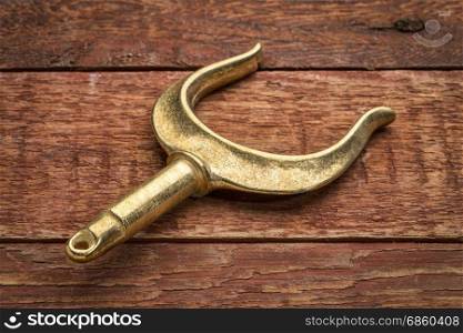 brass rowlocks (oarlock) on rustic weathered barn wood background