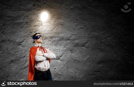 Brave superhero. Young confident superman in mask and cape