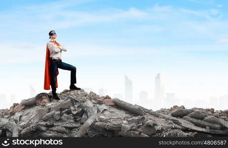 Brave superhero. Young confident superman in mask and cape