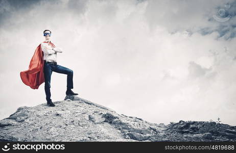 Brave superhero. Young confident superman in mask and cape