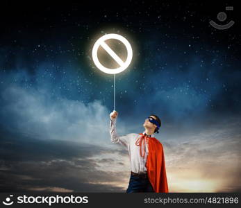 Brave superhero. Young confident superman in mask and cape