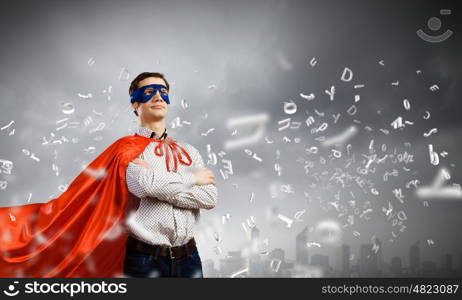 Brave superhero. Young confident superman in mask and cape