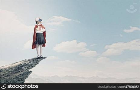 Brave superkid. Cute girl of school age in superhero costume