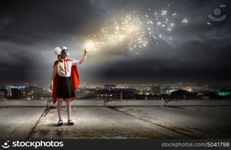 Brave superkid. Cute girl of school age in superhero costume with balloon in hand