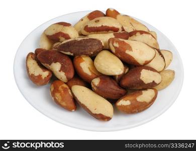 Brazil nut (Bertholletia excelsa) on a white plate on a white background, isolated.