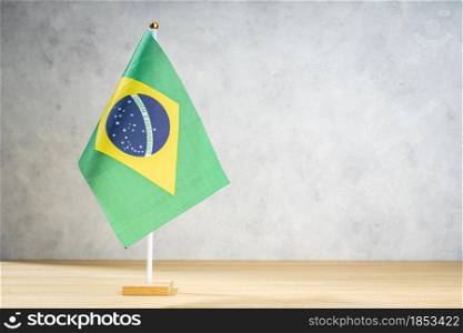 Brazil table flag on white textured wall. Copy space for text, designs or drawings