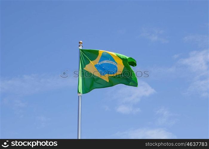 Brazilian flag waving in the mast with blue sky background