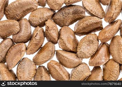 Brazilian nuts in shells against white background