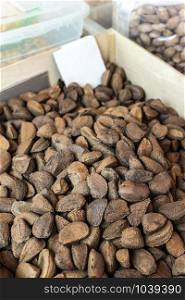 Brazilian nuts on the market. Brazilian nuts with shells.