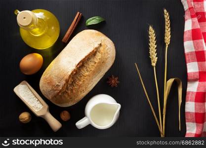 bread and bakery ingredients on wooden background
