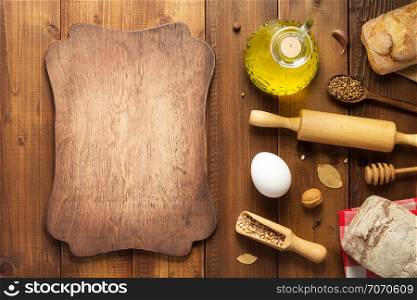 bread and bakery ingredients on wooden table background, top view