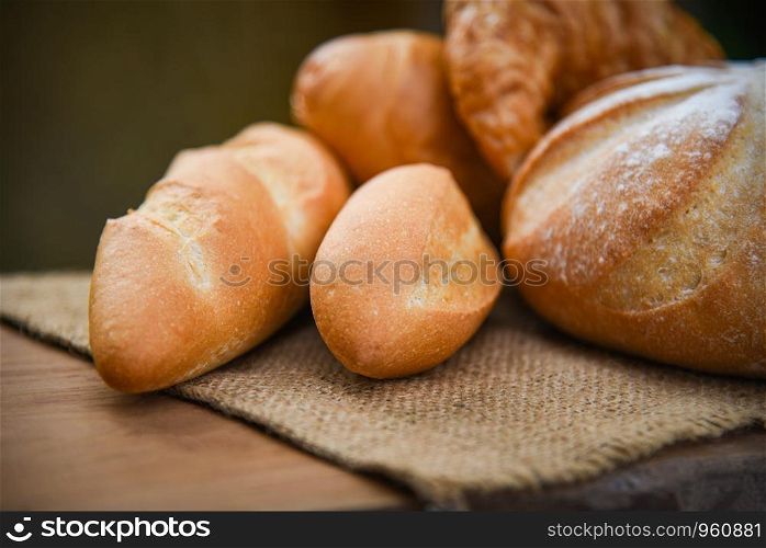 bread and buns assortment / Fresh Bakery bread various types on sack in the rustic table homemade breakfast food concept