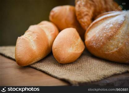 bread and buns assortment / Fresh Bakery bread various types on sack in the rustic table homemade breakfast food concept