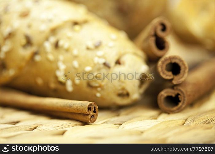 bread and cinnamon sticks on a wicker mat