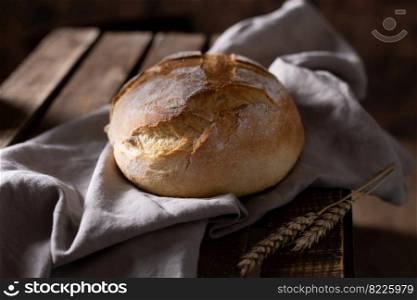Bread and cloth napkin on table. Homemade bread at wooden tabletop as baking concept