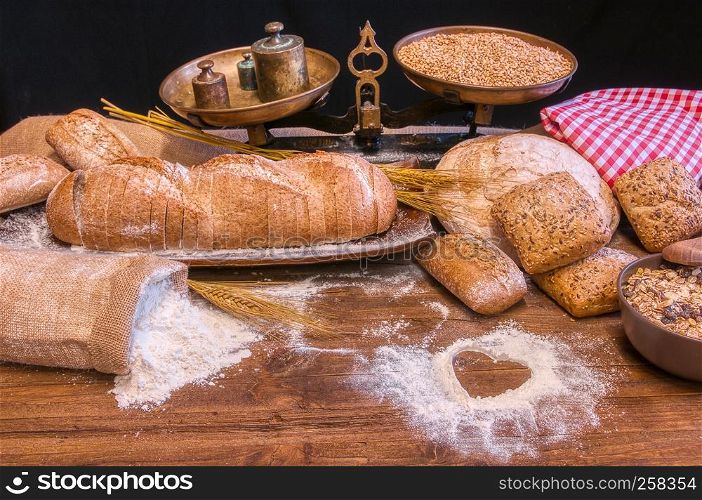 Bread and flour on a rustic wooden table. Bakery and grocery food store concept.