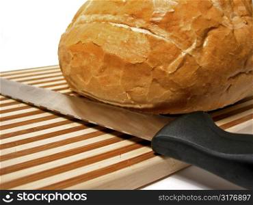 Bread and knife on cutting board, white background
