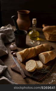 Bread and slices with cutting board on wood table. Homemade bread at wooden tabletop as baking concept